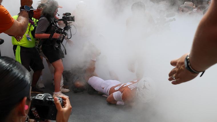 Arch Manning Jokes About Falling Over Videographer in Viral Video During Texas' Smoke Entrance
